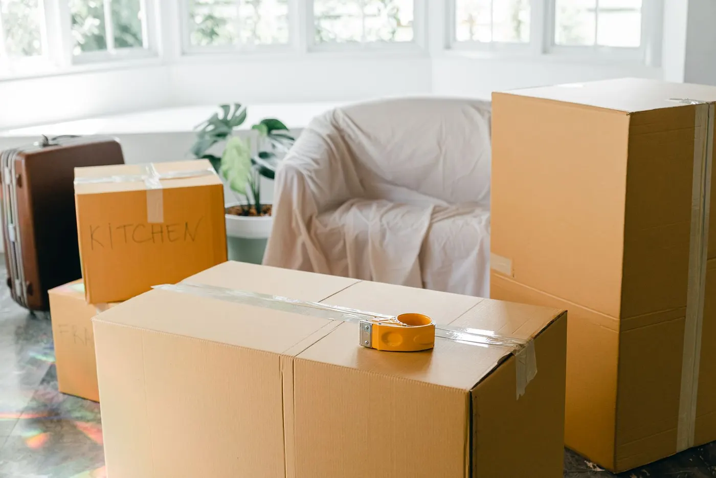 Sunlit living room with packed moving boxes ready for a move